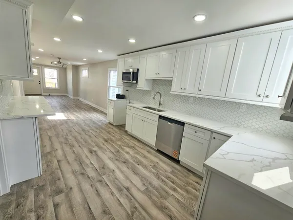 a kitchen with a sink window and cabinets