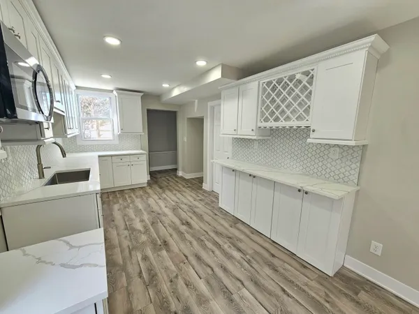 a kitchen with stainless steel appliances granite countertop a sink and cabinets