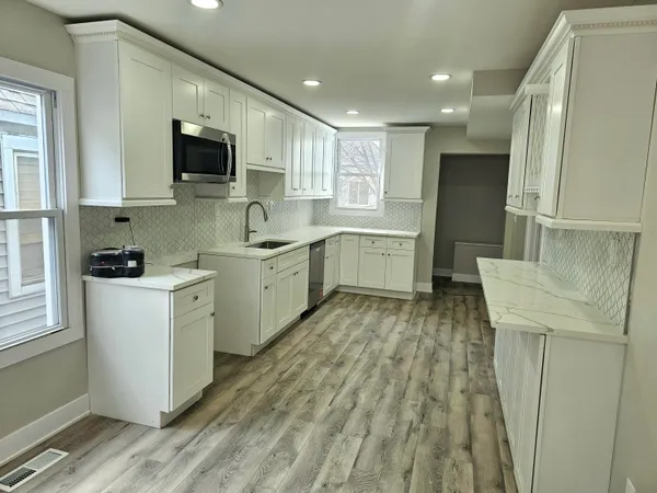 a kitchen with a sink stove and cabinets
