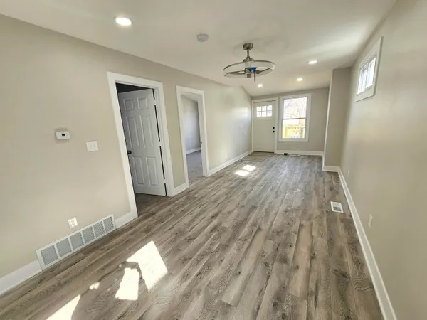 wooden floor in an empty room with a window