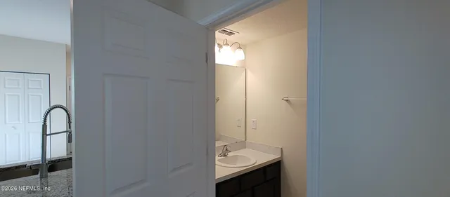 a bathroom with a sink and a mirror
