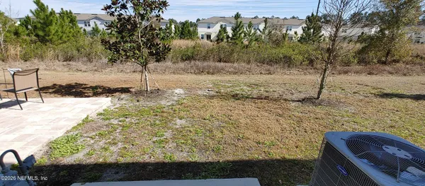 a view of a yard with trees