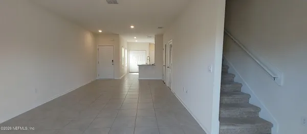 a view of a hallway with stairs