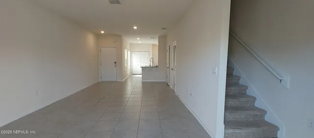 a view of a hallway with stairs