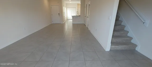 a view of an entryway with wooden floor