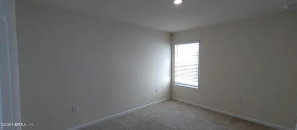 a view of an empty room and a window