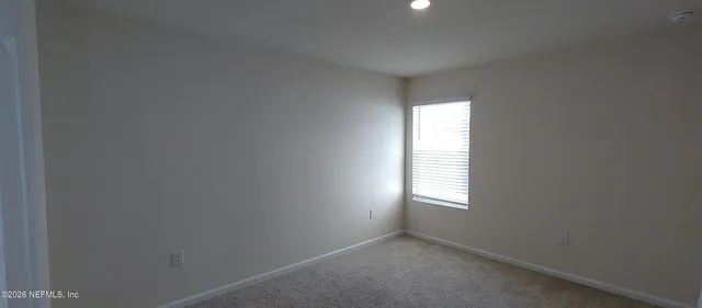 a view of an empty room and a window