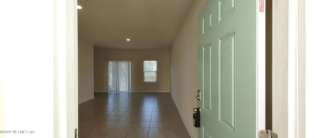 a view of hallway with wooden floor