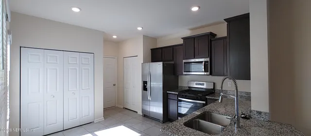 a kitchen with a refrigerator and a sink