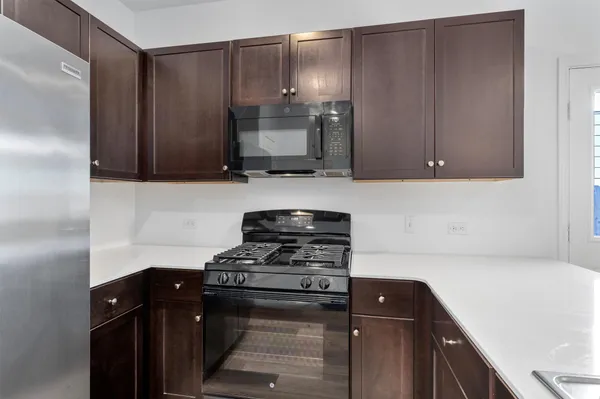 a kitchen with a sink and a refrigerator