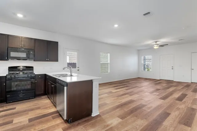 a kitchen with stainless steel appliances granite countertop a stove a sink and a refrigerator