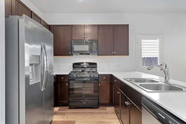 a kitchen with a stove microwave and sink