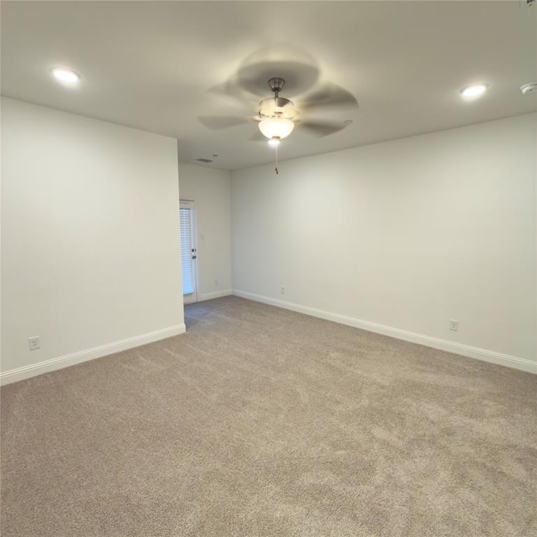 2541 Brunswick Way Allen, TX 75013 - Photo 14 of 20 an empty room with a chandelier fan and windows