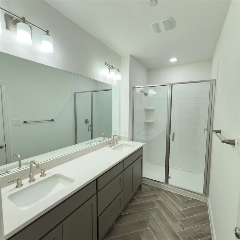 2541 Brunswick Way Allen, TX 75013 - Photo 17 of 20 a bathroom with a double vanity sink mirror and shower