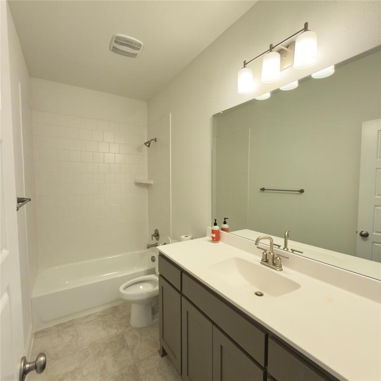 2541 Brunswick Way Allen, TX 75013 - Photo 19 of 20 a bathroom with a sink a toilet and shower