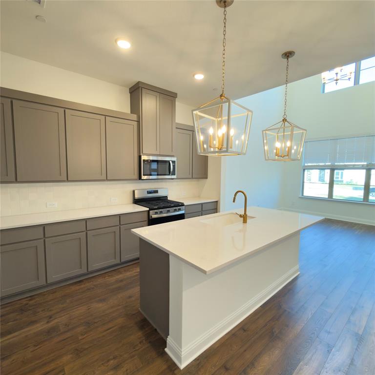 2541 Brunswick Way Allen, TX 75013 - Photo 7 of 20 a kitchen with a sink cabinets and wooden floor