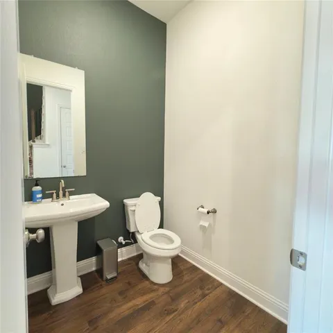 a white toilet sitting next to a bathroom sink