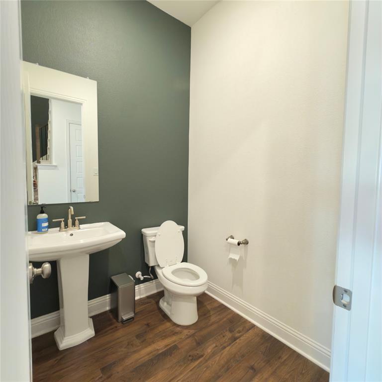 2541 Brunswick Way Allen, TX 75013 - Photo 9 of 20 a white toilet sitting next to a bathroom sink