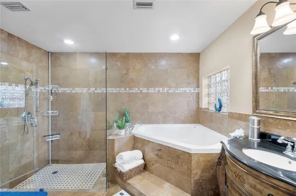 a bathroom with a tub sink toilet and shower