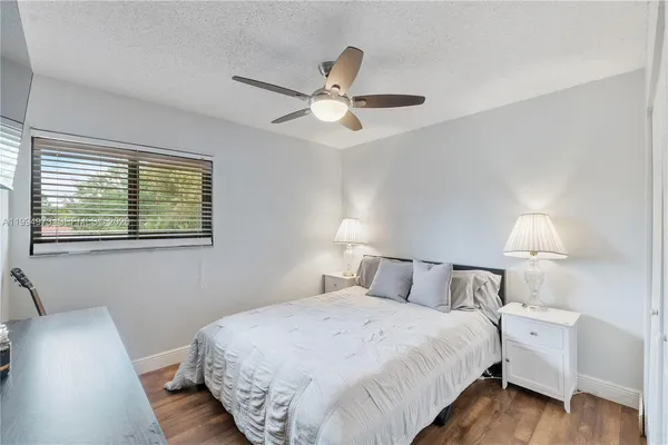 a bedroom with bed and a window