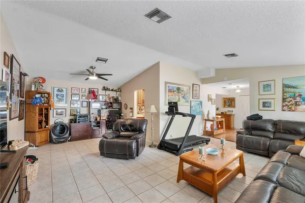 a living room with furniture a couch and a flat screen tv