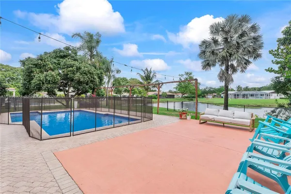 a view of a backyard with swimming pool