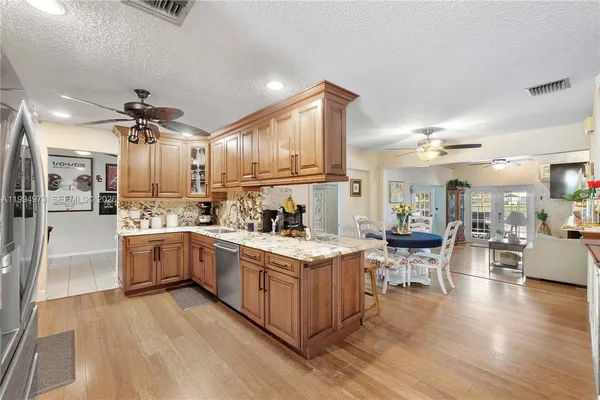 a open kitchen with cabinets a sink and stainless steel appliances
