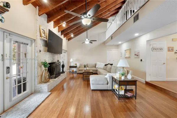 a living room with furniture and a wooden floor