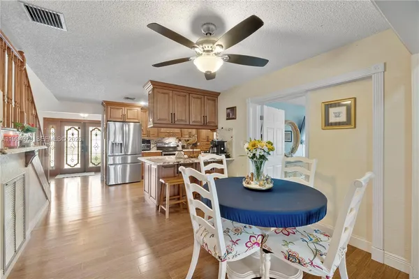 a dining room with wooden table and chairs