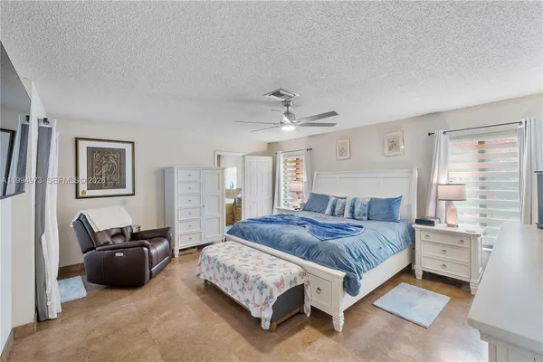 a living room with a bed furniture and a window