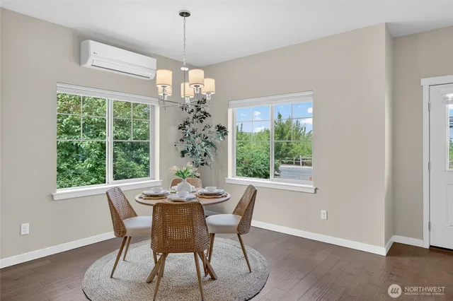 a dining room with furniture a chandelier and wooden floor