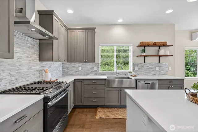 a kitchen with stainless steel appliances granite countertop a sink stove and cabinets