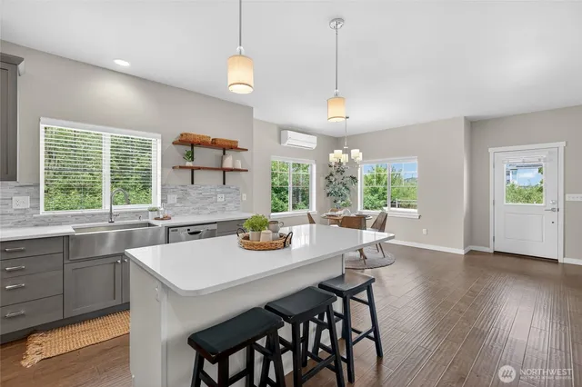 a kitchen with a table chairs and wooden floor