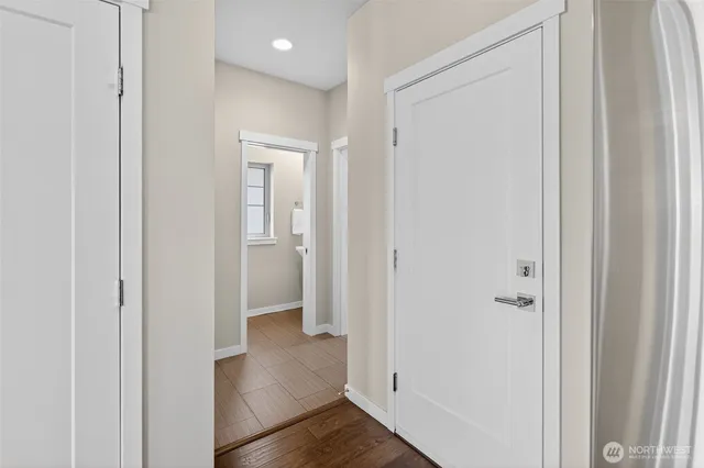 a view of a hallway with wooden floor