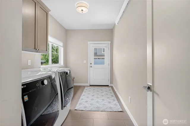 a view of a kitchen with a sink washer and dryer