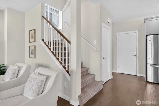 a view of entryway and hall with wooden floor
