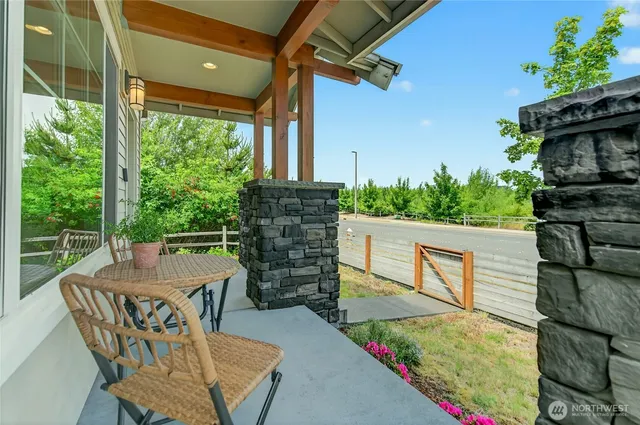a view of a patio with table and chairs with wooden floor and fence