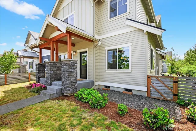 a front view of a house with plants