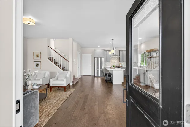 a living room with furniture and a table with wooden floor