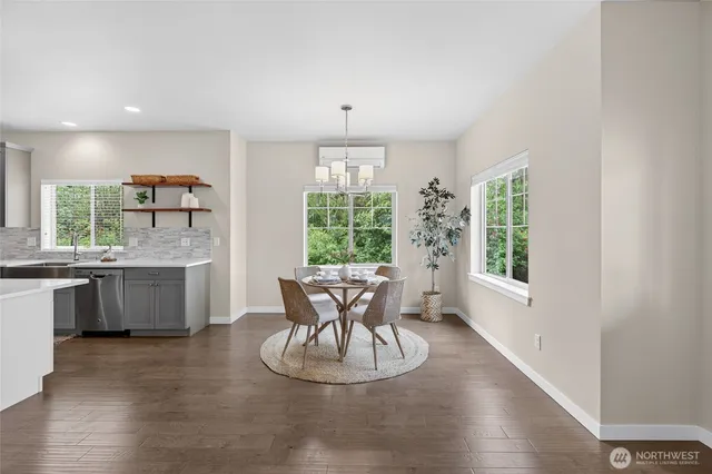 a dining room with furniture a window and wooden floor
