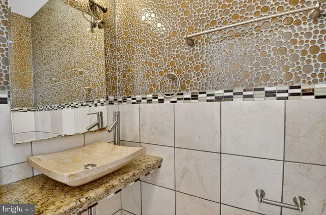 a large kitchen with stainless steel appliances kitchen island granite countertop a refrigerator and a sink