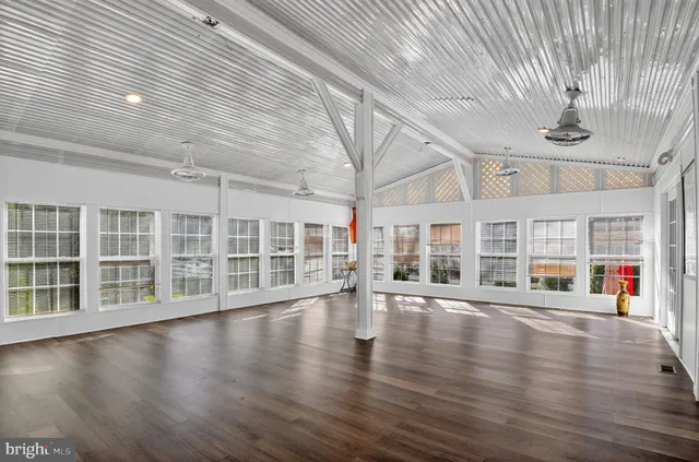 a view of a livingroom with wooden floor and a fireplace