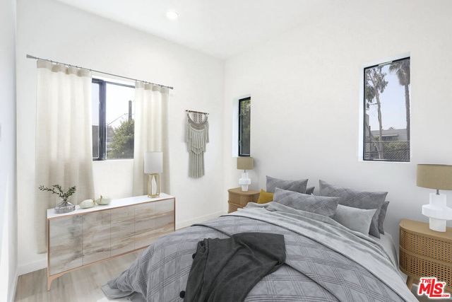 a bedroom with a large bed and a window