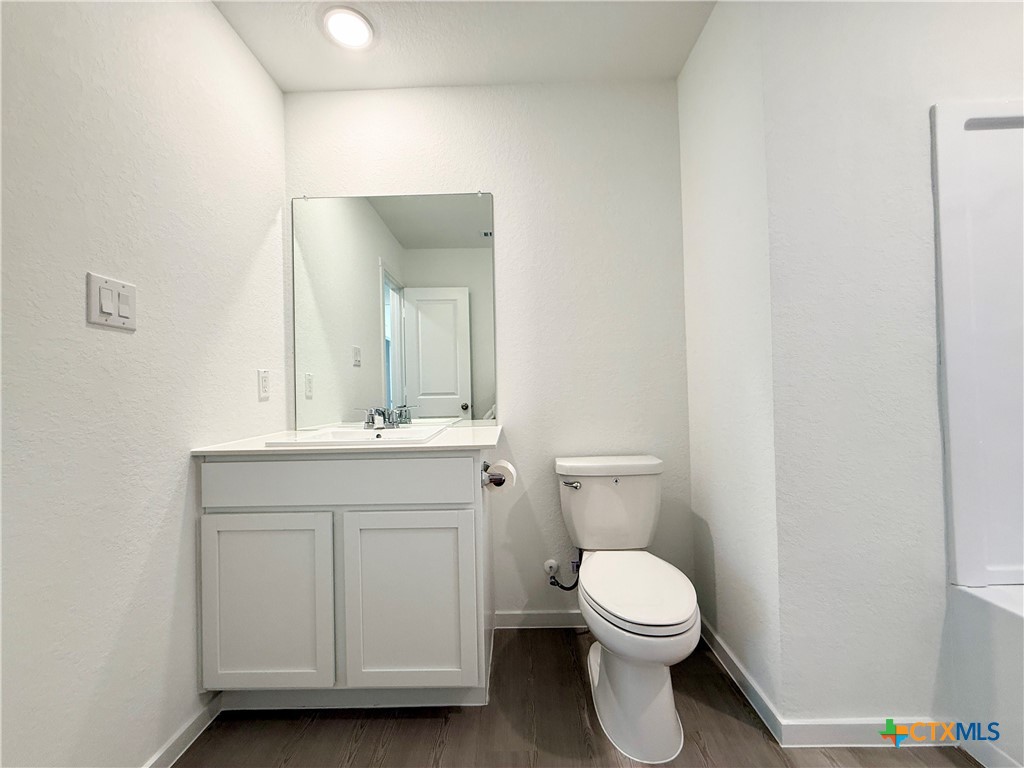311 Moscato Road New Braunfels, TX 78130 - Photo 20 of 38 a bathroom with a toilet a sink and mirror