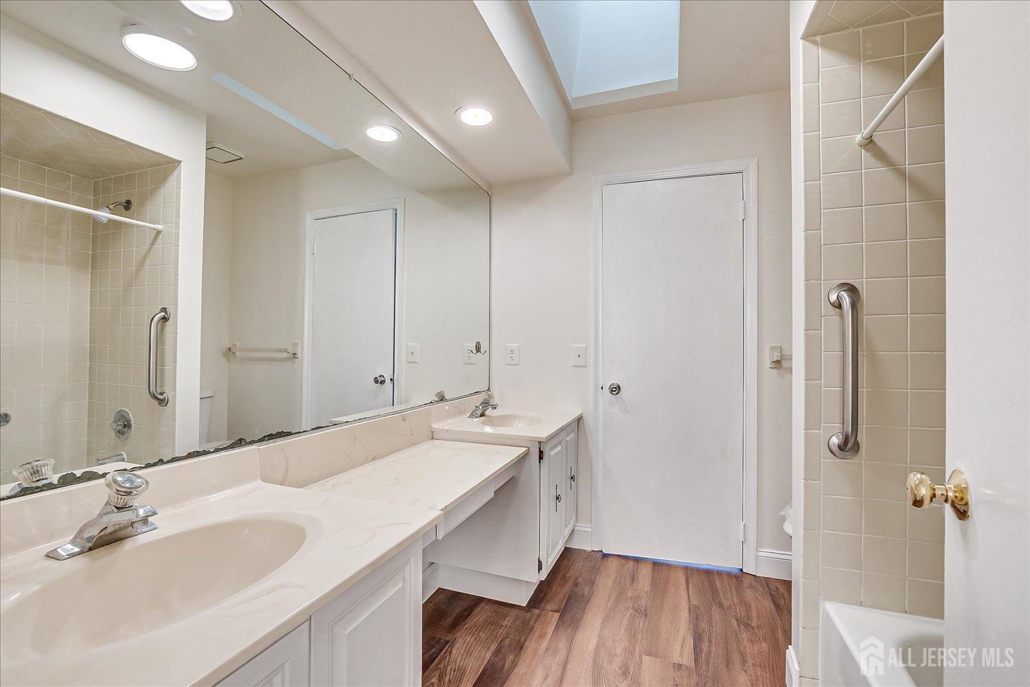 605 Maplecrest Road Edison, NJ 08820 - Photo 23 of 37 a bathroom with a double vanity sink and mirror
