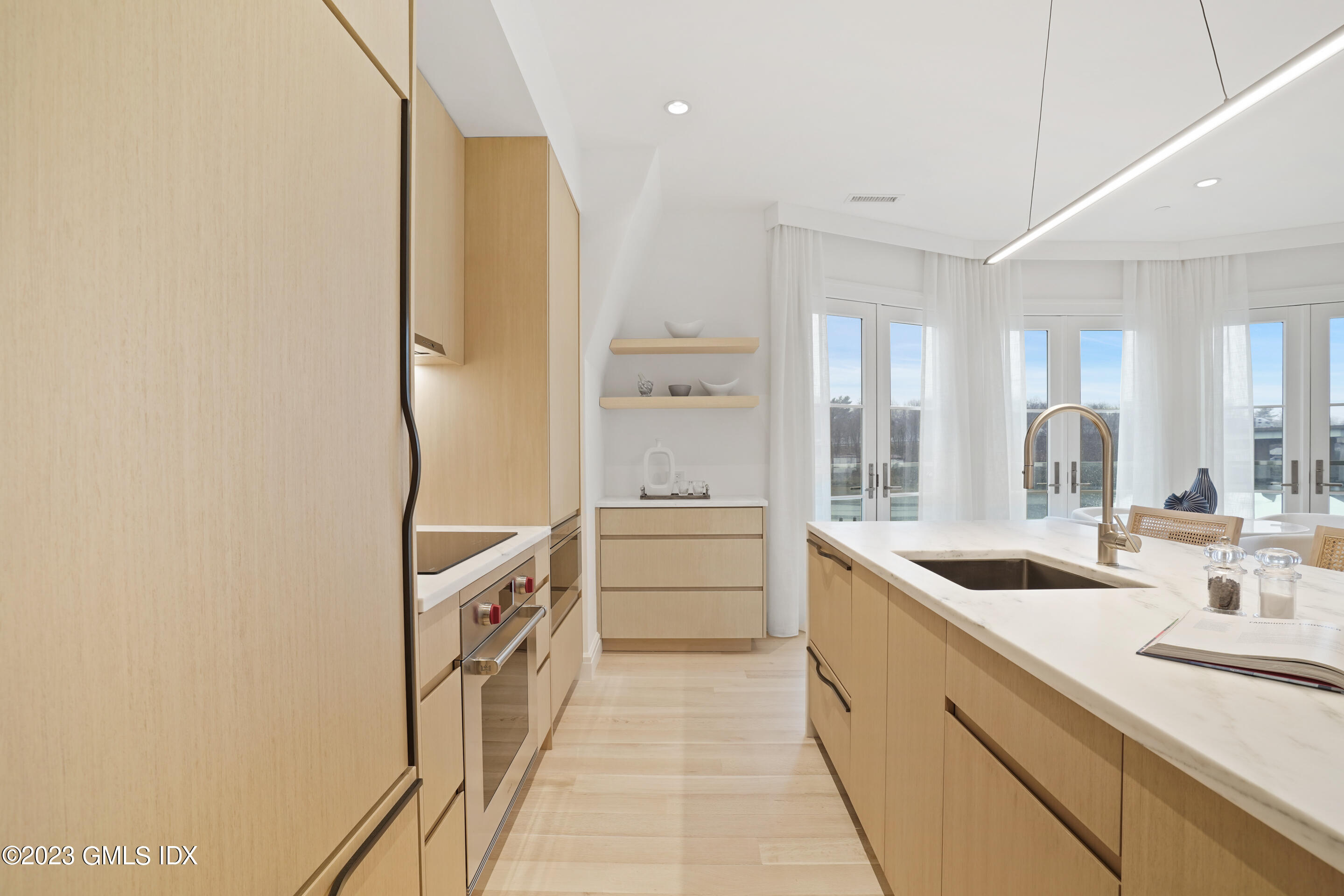 89 River Road, Unit 304 Cos Cob, CT 06807 - Photo 4 of 20 a kitchen with a sink a stove a refrigerator and cabinets