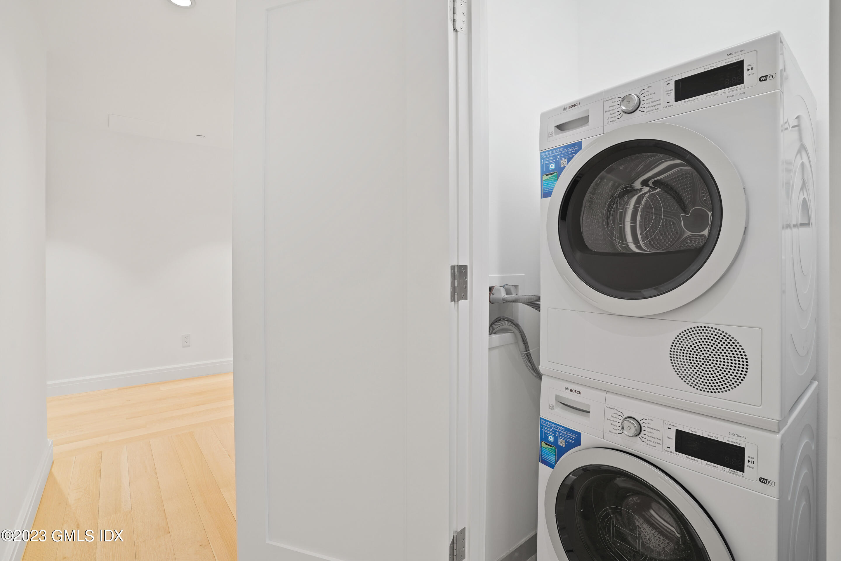 89 River Road, Unit 304 Cos Cob, CT 06807 - Photo 8 of 20 a utility room with dryer and washer