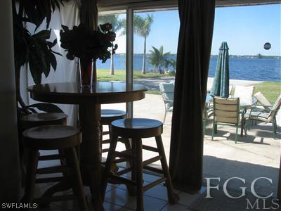 142 Riverview Road Fort Myers, FL 33905 - Photo 1 of 13 a view of swimming pool from a dining room