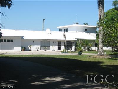 142 Riverview Road Fort Myers, FL 33905 - Photo 11 of 13 a front view of a house with garden
