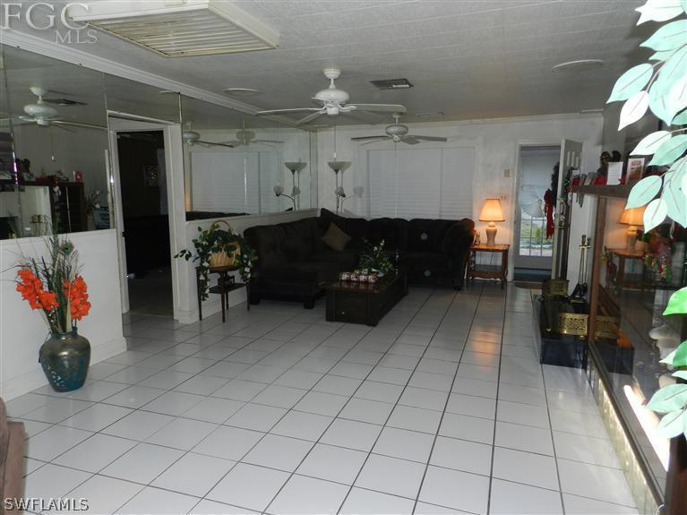 142 Riverview Road Fort Myers, FL 33905 - Photo 12 of 13 a living room with furniture and a flat screen tv
